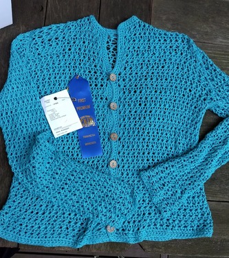 Cardigan with a Twist and a Pop from Workbasket Magazine April 1981 in turquoise Bamboo Pop yarn with a 1st place ribbon